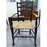 An early 20thC stained beech ladderback chair with a rush seat,