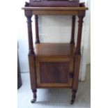 A late Victorian mahogany bedside cupboard with a panelled door,