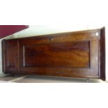 A late Victorian flame mahogany finished hallrobe with a moulded cornice, over a panelled door,