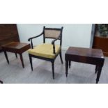 Small furniture: to include a Regency ebonised framed open arm chair with a caned back and seat,