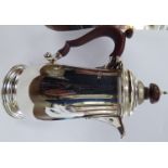 A Georgian style small silver hot water pot of tapered baluster form with an insulated handle and