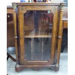 A late Victorian satinwood and ebony inlaid walnut music cabinet with a panelled door,