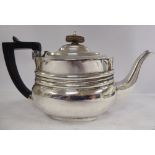 An Edwardian bachelor's silver teapot of oval, ogee form with a swept spout,