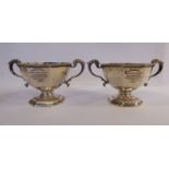 Two identical silver replicas of The Little Aufrics Cup of octagonal form with opposing,