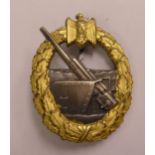 A German Naval Coastal Gun badge, stamped Schwerin,