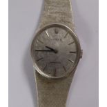 A lady's 1970s Rolex white coloured gold oval cased, flexible link bracelet wristwatch,