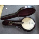 An eight string banjo with inlaid ornament and a manufacturer's Crowned Eagle emblem,