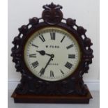 A late Victorian retailer's mahogany cased timepiece with a boldly scroll and bellflower carved