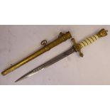 A German Naval dagger with a woven wire handgrip and eagle pommel,