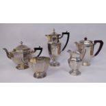 A five piece silver tea and coffee set of panelled octagonal pedestal bowl design comprising a