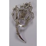 A white coloured gold ribbon tied and diamond set floral spray brooch stamped 750