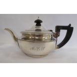 A late Victorian bachelor's silver teapot of circular form with a swept spout,