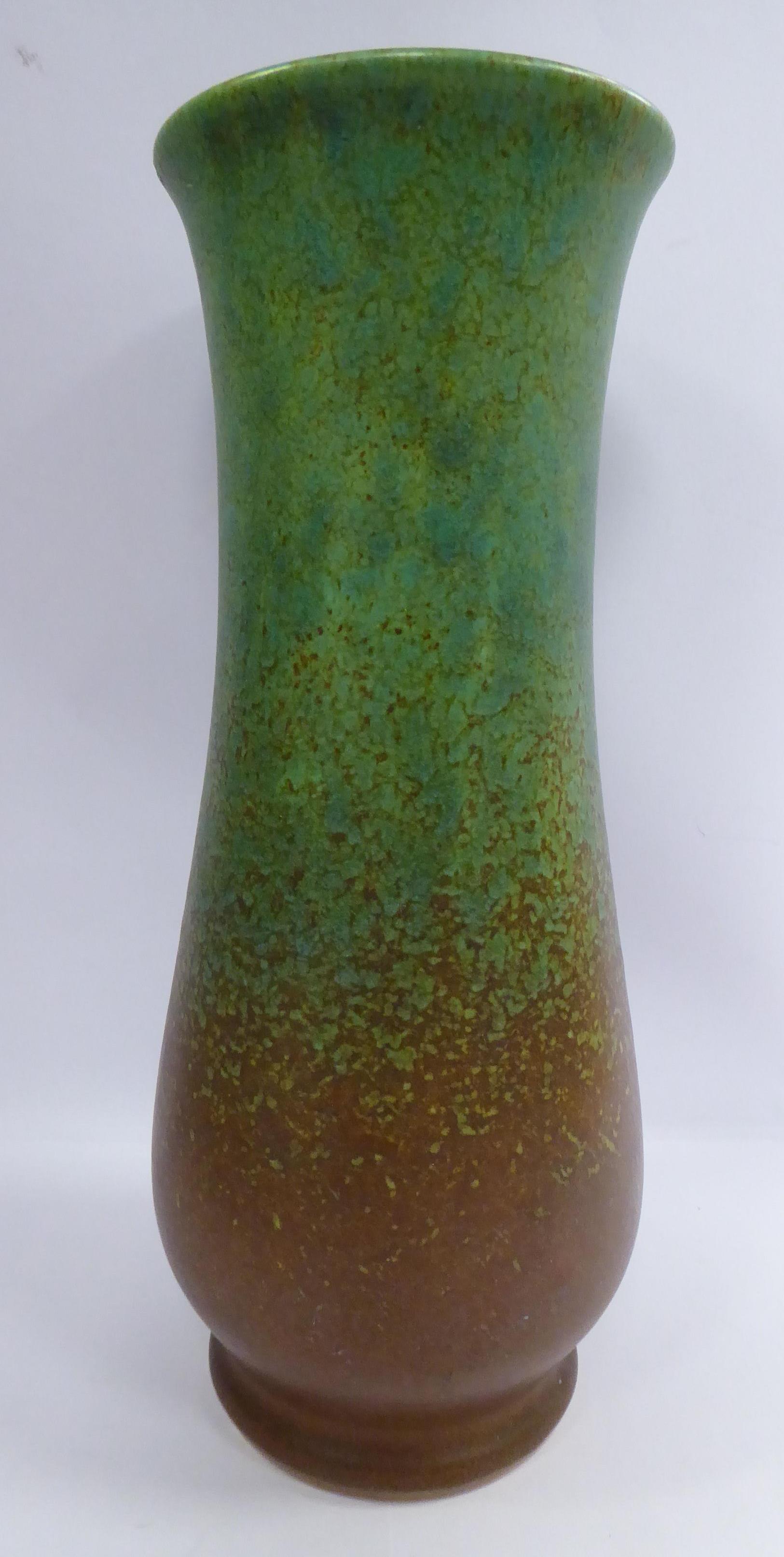 A Royal Lancastrian sponged brown and green glazed pottery vase of slender,