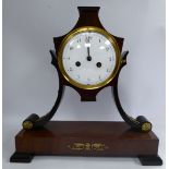 A late 19thC Continental Empire style mahogany cased mantel clock with decoratively cast,