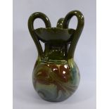 A Barum ware green and brown, part marbelised glazed pottery jug of bulbous form with a narrow neck,