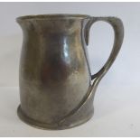A 'Tudric' spot-hammered pewter half-pint tankard for Liberty & Co of waisted baluster form with a