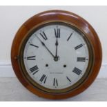 An early 20thC North American mahogany cased wall clock with a turned surround;