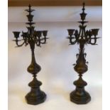 A pair of early 20thC cast and patinated bronze candelabra,