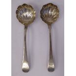 A pair of Georgian silver Old English sauce ladles with shell pattern bowls,