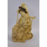 An early 20thC Japanese two-dimensional carved and stained ivory figure,