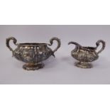 A William IV silver cream jug of segmented, circular form, on a pedestal footrim,