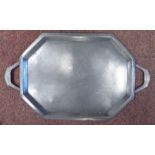 An early 20thC BCM/'Tudric' spot-hammered pewter tray of elongated octagonal form with opposing