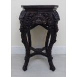 A late 19th/early 20thC Anglo-Indian profusely carved octagonal hardwood jardinere stand,