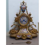 A late 19thC French, elaborately cast gilt, metal cased mantel clock with painted porcelain panels,