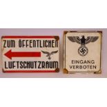 Two German enamelled steel signs, each bearing a swastika emblem,