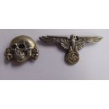 A German SS white metal skull and associated eagle insignia