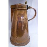 An Arts & Crafts copper flagon of tapered form with a rivetted strap handle,