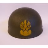 A Polish parachuter's khaki coloured steel helmet with a chin strap,