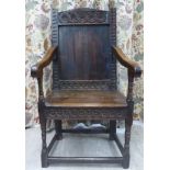 A late 18thC oak framed wainscot chair with Vitruvian scroll carved ornament, a high panelled back,