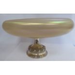 An early 20thC vaseline coloured opaque, lustre glass fruit bowl of shallow, bulbous form,