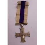 A British 1942 Military Cross with a ribbon,