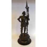 A late 19thC cast and patinated bronze figures, a standing Spanish soldier, wearing full armour,