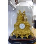 A late 19thC French elaborately cast gilt metal cased mantel clock, featuring a standing woman,