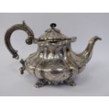 A William IV silver melon design teapot of squat form with a swept spout,