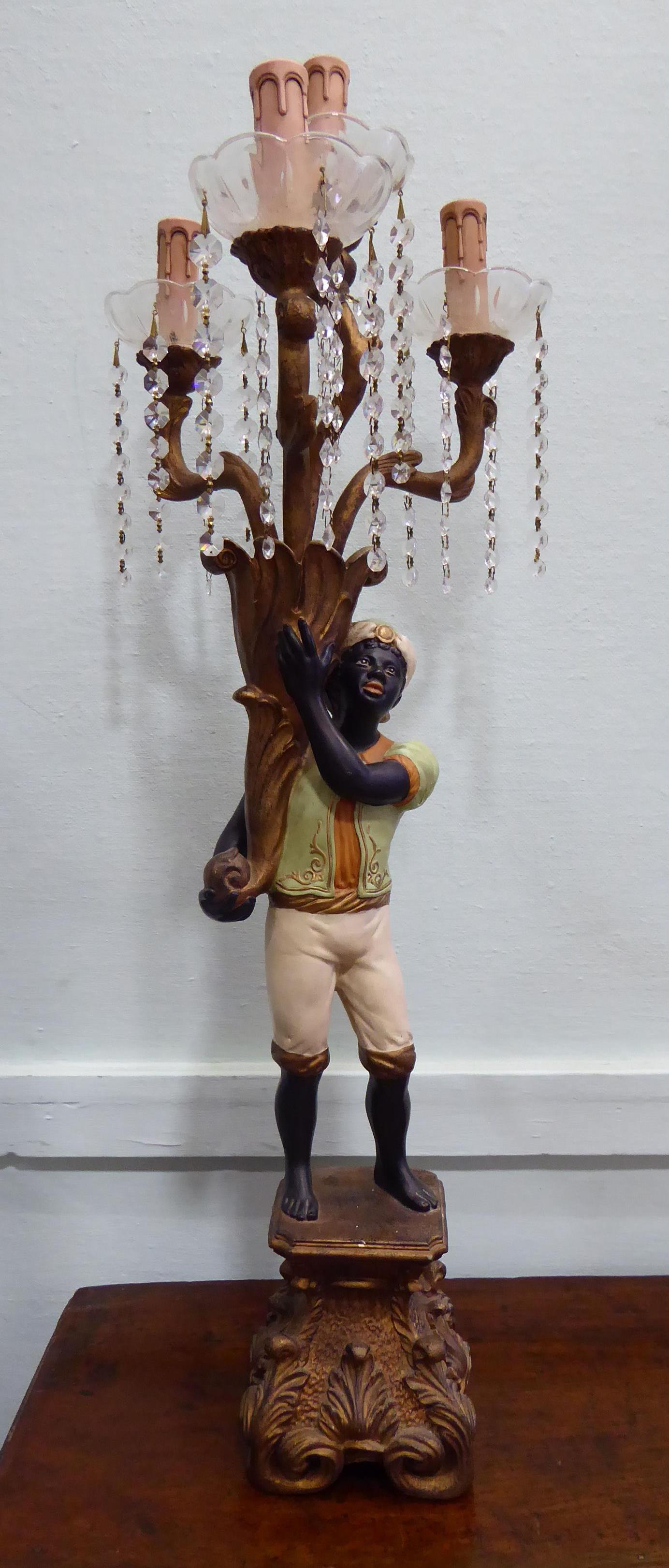 A 19thC style blackamoor table lamp, the standing figure elevating a cornucopia and four,