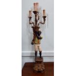 A 19thC style blackamoor table lamp, the standing figure elevating a cornucopia and four,