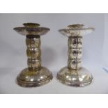 A matched pair of Arts & Crafts WMF spot-hammered silver plated candlesticks,