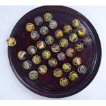 Thirty-four Victorian Latticinio multi-coloured cane cut glass 'marbles' and a later,