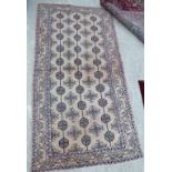 A Persian design rug with stylised designs on a faded pink ground 95'' x 50'' RAF