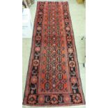 A Persian design runner with two columns of fourteen guls bordered by stylised designs 44'' x