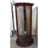 A modern mahogany finished and floral marquetry, fully glazed, cylindrical display cabinet,