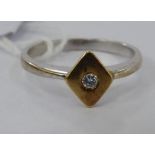 An 18ct bi-coloured gold ring, set with a single diamond,