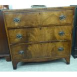 An early 19thC flame veneered mahogany dressing chest,