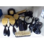 Early 20thC ebony and ebonised desktop and dressing table accessories: to include brushes and hand