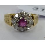 An 18ct textured gold claw set ruby and diamond cluster ring 11