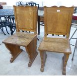 A pair of mid 20thC bleached mahogany boarded side chairs with relief carved,